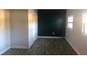 Simple bedroom with dark gray flooring and a dark teal accent wall at 5900 Judy Dee Dr, Orlando, FL 32808