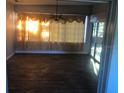 Bright dining room with dark wood-look floors and sliding glass doors at 5900 Judy Dee Dr, Orlando, FL 32808