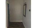 Clean entryway with wood-look flooring, a mirror, and a door at 5900 Judy Dee Dr, Orlando, FL 32808