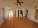 Living room with hardwood floors, built-in shelving, and vaulted ceilings at 7914 Goldleaf St, Orlando, FL 32835