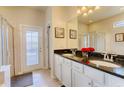 Bathroom with double vanity, granite countertop and glass shower at 8879 Menton Loop, Kissimmee, FL 34747