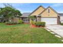 House exterior showcasing a well-maintained lawn and landscaping at 12512 Tillingham Sw Ct, Orlando, FL 32837