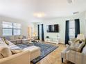 Spacious living room with sectional sofa, large TV, and decorative rug at 1522 Moon Valley Dr, Davenport, FL 33896