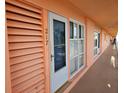 Condo hallway with light peach walls, white doors, and windows offering natural light at 721 S Beach St # 217A, Daytona Beach, FL 32114