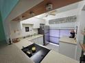 Bright kitchen with white cabinets, stainless steel appliances, and a tiled floor at 721 S Beach St # 217A, Daytona Beach, FL 32114