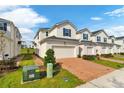Two story townhome with two-car garage and brick paver driveway at 1174 Seaside Mist Trl, Kissimmee, FL 34747