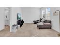 Living room features an L-shaped sofa and a large TV at 1174 Seaside Mist Trl, Kissimmee, FL 34747