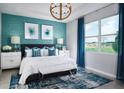 Spacious bedroom with teal walls, and a king-size bed at 2018 Firethorn Loop, Haines City, FL 33844