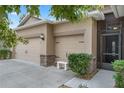 Tan house with three car garage, stone accents, and lush landscaping at 5307 Cortland Dr, Davenport, FL 33837