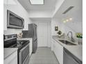 Modern kitchen with stainless steel appliances and white cabinets at 770 Siena Palm Dr # 305, Celebration, FL 34747