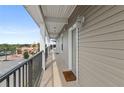 Exterior hallway with doors to individual units and distant shops at 831 Retreat Blvd # 402, Davenport, FL 33897