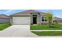 One story house with a green exterior, two car garage, and manicured lawn at 1117 Star Ruby Ln, Winter Haven, FL 33880