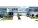 Two-story townhouse exterior, two-car garage, and front landscaping at 4778 Sparkling Shell Ave, Kissimmee, FL 34746