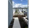 Sidewalk view between townhouses showing additional homes at 4778 Sparkling Shell Ave, Kissimmee, FL 34746