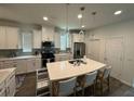 Spacious kitchen with island, stainless steel appliances, and white cabinets at 15121 Pigeon Plum Ln, Winter Garden, FL 34787