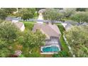 Aerial view of a house with a screened-in pool at 3857 Fallscrest Cir, Clermont, FL 34711