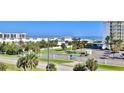 Aerial view of beachfront property with ocean view, tropical landscaping, and recreational amenities at 5300 S Atlantic Ave # 2-502, New Smyrna Beach, FL 32169