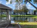 Relaxing pond view with gazebo and manicured landscaping at 2030 Cascades Blvd # 302, Kissimmee, FL 34741