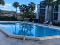 Community swimming pool with surrounding patio area at 2030 Cascades Blvd # 302, Kissimmee, FL 34741
