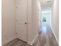 Bright hallway with light gray vinyl flooring and white doors at 2076 Cades Cove Way, Deland, FL 32720