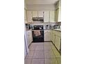 Kitchen with white cabinets, black appliances, and granite countertops at 2314 Carriage Run Rd, Kissimmee, FL 34741