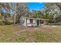 Updated home with teal front door, covered porch, and large yard at 2677 Cr 422, Lake Panasoffkee, FL 33538