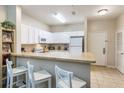Efficient kitchen with white cabinets, breakfast bar and modern appliances at 3177 Feltrim Pl # 104, Kissimmee, FL 34747