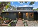 Inviting front entrance with a walkway, landscaping, and a wood front door at 4834 Hall Rd, Orlando, FL 32817