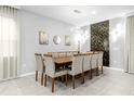 Spacious dining room with large wooden table and seating for twelve at 8881 Qin Loop, Kissimmee, FL 34747