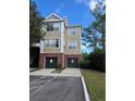 Tan three-story building with two-car garages at 13103 Mulberry Park Dr # 817, Orlando, FL 32821