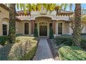 Elegant entryway with a brick pathway, lush landscaping, and a grand double door at 1720 Brackenhurst Pl, Lake Mary, FL 32746