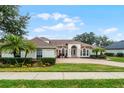 House with a double door entry and manicured landscaping at 1869 Merlot Dr, Sanford, FL 32771