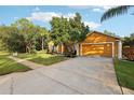 House exterior showcasing a two-car garage, landscaping, and driveway at 20575 Nettleton St, Orlando, FL 32833