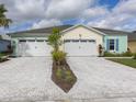 Two-story home with attached garages and a shared paved driveway at 320 Low Tide Ln, Daytona Beach, FL 32124