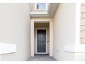 Dark gray front door entrance with brick walkway at 1166 Presidential Ln, Apopka, FL 32703