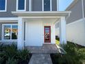 Front entry with red door and stone walkway at 2007 Iorio St, Saint Cloud, FL 34771