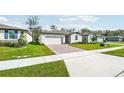 New home community with multiple houses, landscaping, and sidewalks at 28054 Poppy Ct, Leesburg, FL 34748