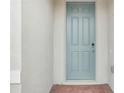 Light blue front door with a keypad entry and brick walkway at 4736 Jasmine Cir, Leesburg, FL 34748