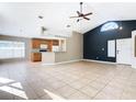 Open floor plan with kitchen island, wood cabinets, and tile flooring at 4929 Dunmore Ln, Kissimmee, FL 34746