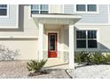 Inviting front entrance with a red door and stone accents at 7916 Waterfield Ave, Orlando, FL 32832