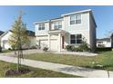 Two-story house with gray siding, red door, and a landscaped yard at 7916 Waterfield Ave, Orlando, FL 32832