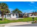 Charming ranch home with modern updates, covered patio, and well-manicured lawn at 1023 Neuse Ave, Orlando, FL 32804