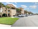 Condo building with parking and lush landscaping at 449 Bouchelle Dr # 304, New Smyrna Beach, FL 32169