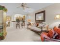 Bright living room features a comfy sofa and kitchen view at 12843 Madison Pointe Cir # 107, Orlando, FL 32821