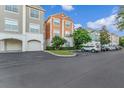 Condo building with various color schemes and parking at 12843 Madison Pointe Cir # 107, Orlando, FL 32821