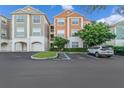 Two-story condo building with ample parking and landscaping at 12843 Madison Pointe Cir # 107, Orlando, FL 32821
