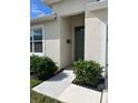 Inviting front entry with green door and landscaping at 2243 Tay Wes Dr, Saint Cloud, FL 34771