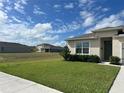 Newly built home with a two-car garage and well-manicured lawn at 2243 Tay Wes Dr, Saint Cloud, FL 34771