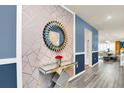 Elegant entryway with geometric wallpaper and a statement mirror at 3032 Mahalo Dr, Davenport, FL 33897