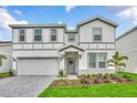 Two-story home with gray siding and gray paved driveway at 3032 Mahalo Dr, Davenport, FL 33897